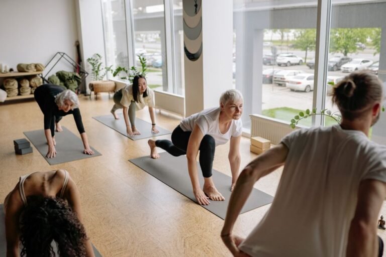 Beginner student following an instructor's cues during a yoga class