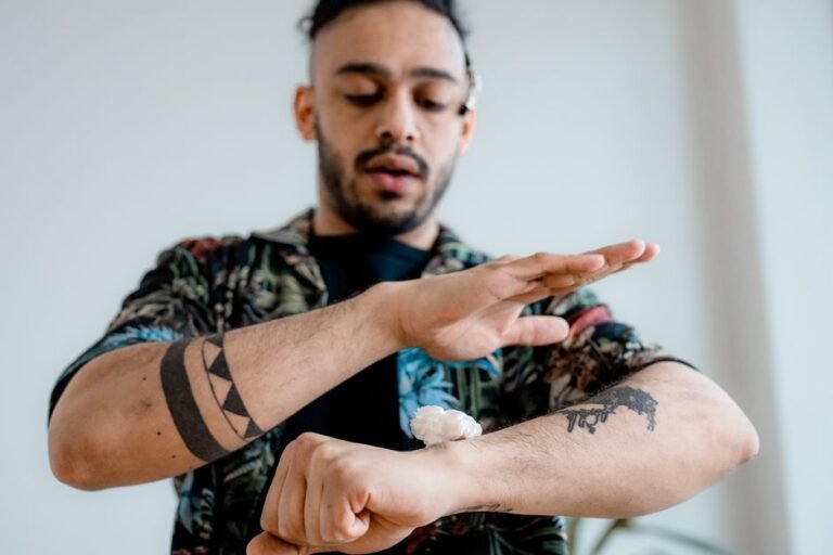 A person applying a small dab of skincare product to the inside of their forearm