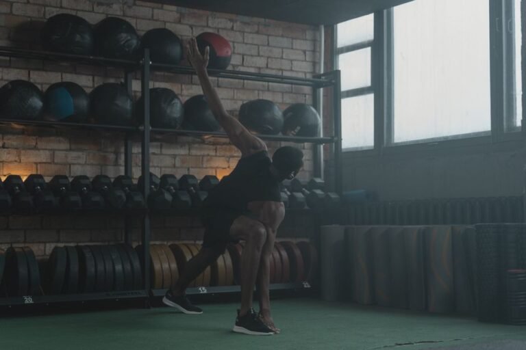 A person doing a light dumbbell exercise in a gym, moving at an easy, controlled pace