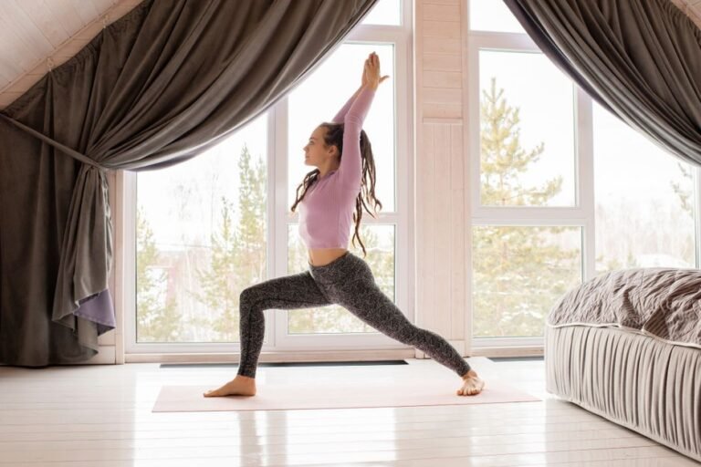 Person stretching near a window in the evening after a workout