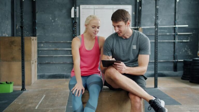 A person checking a simple written workout plan on paper before starting to exercise