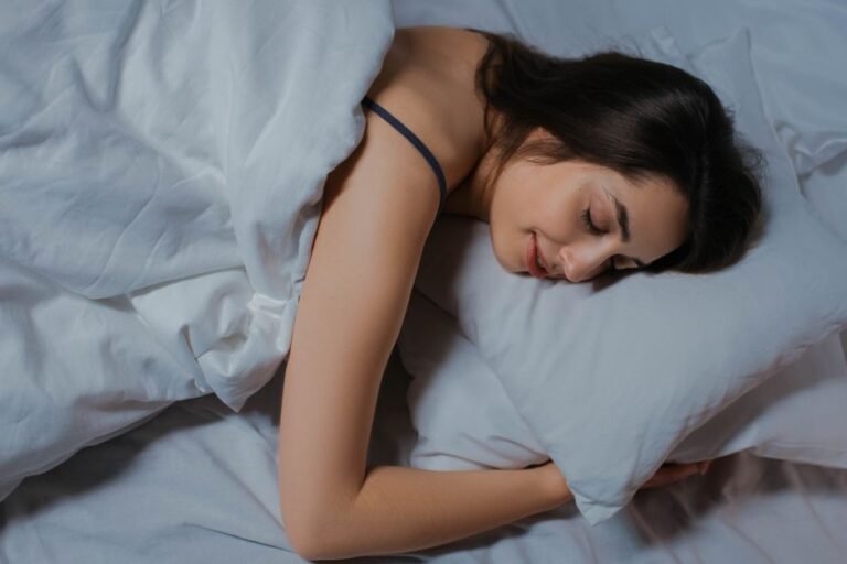 A person sleeping peacefully in a dark, quiet bedroom
