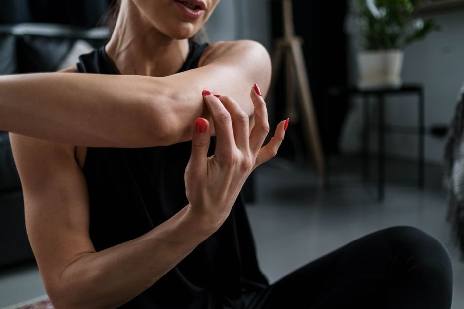 A person gently stretching their legs after a workout