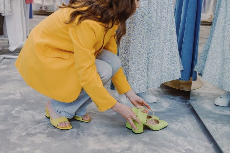 A person trying on a pair of running shoes while seated in a shoe store