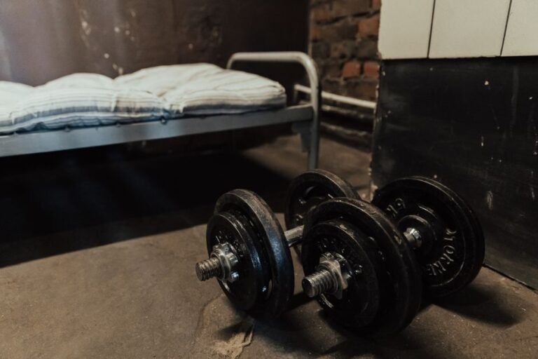 A home gym corner with an adjustable bench, dumbbells, and resistance bands