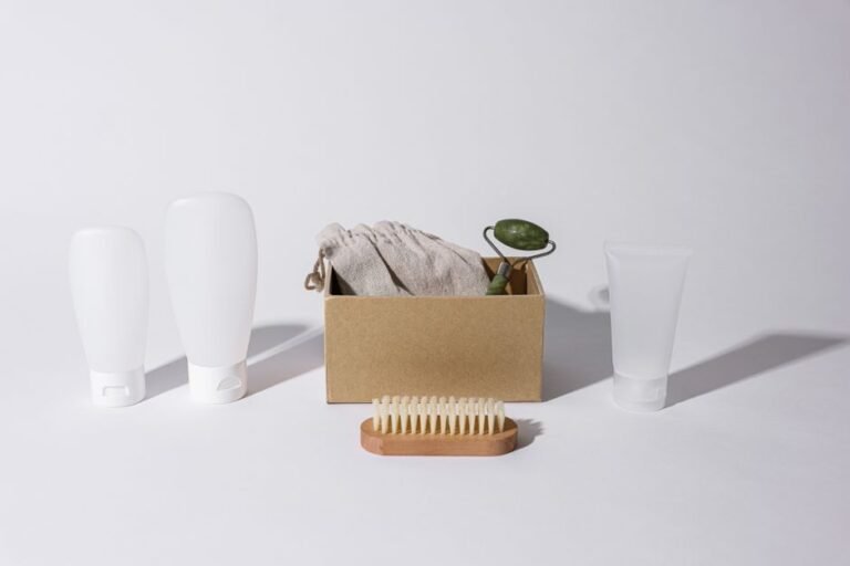Small travel-size skincare bottles and tubes packed into a clear toiletry bag
