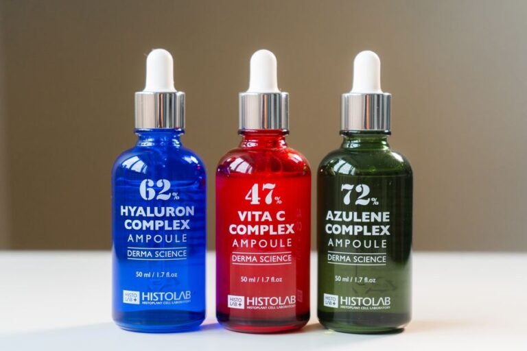 An amber glass dropper bottle of serum standing on a bathroom shelf