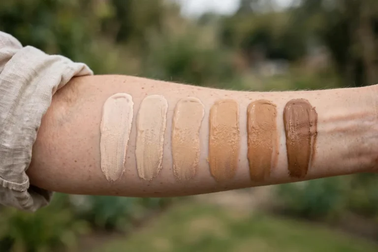 Foundation shade swatches in different skin tones on a forearm for choosing foundation online